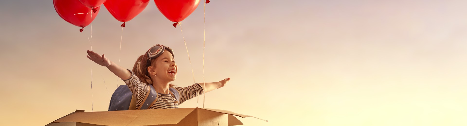 Girl flying with balloons