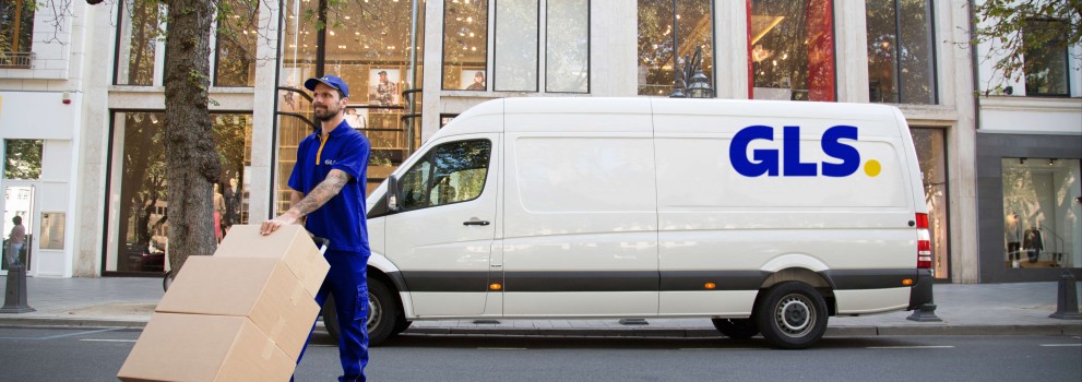 GLS courier handling parcels with a GLS van in the background