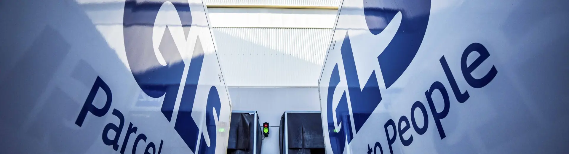 Two GLS trucks parked outside depot